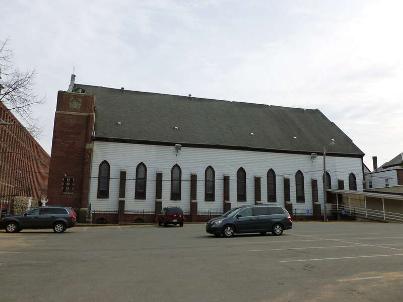 The north side of Holy Rosary Church.   Located on the corner of Essex Street and Union Street in Lawrence, Massachusetts.