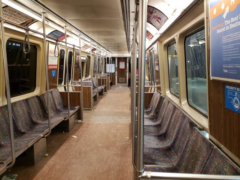 Interior of an MBTA Orange Line car 01292 (Bombardier 1200 series) at night in March 2018 while waiting at Oak Grove station