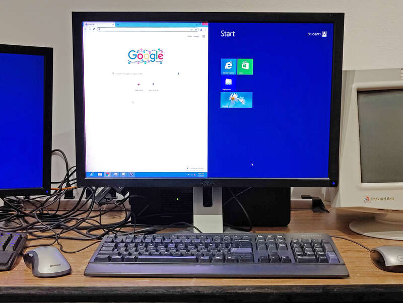 Microsoft Windows Multipoint Server 2012 displaying two concurrent desktop sessions (controlled by two separate sets of keyboards and mice) on one monitor, using the &quot;split station&quot; feature
