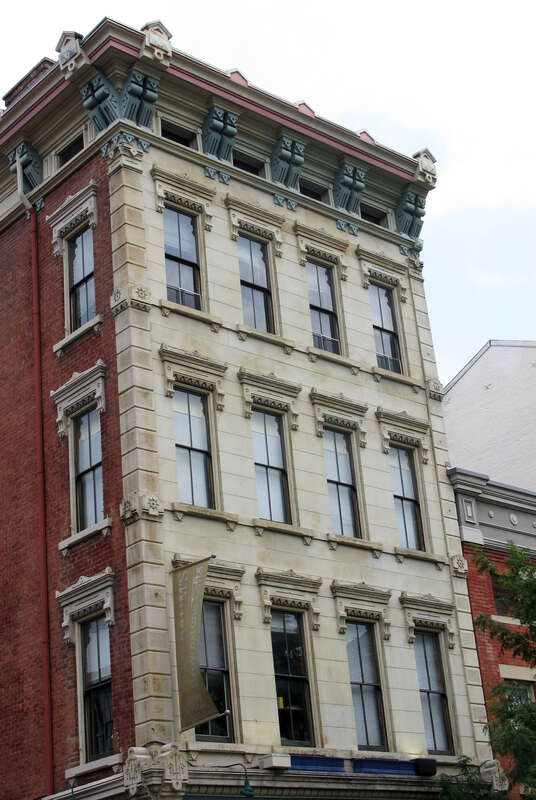 Italianate greystone (mislabeled as a brownstone) building with decorative cornices.