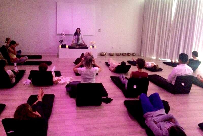 Olivia Rosewood guides a public class in meditation.