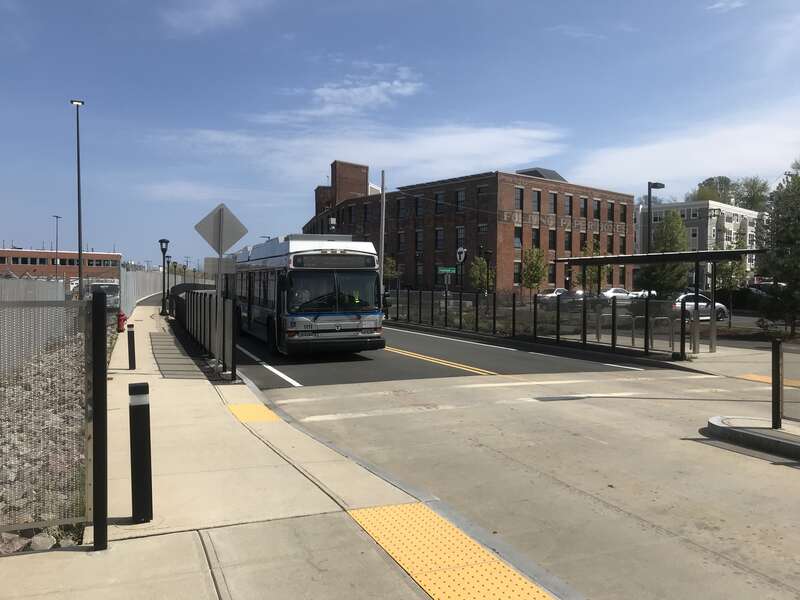 An outbound MBTA Silver Line bus arriving at Box District station in April 2021