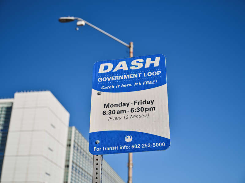 A sign for the Valley Metro DASH Government Loop bus in downtown Phoenix, Arizona. &quot;Catch it here. It's free! Monday - Friday 6:30am - 6:30 pm (Every 12 minutes) For transit info: 602-253-5000&quot;