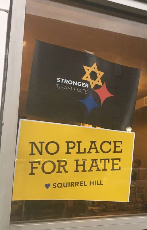 Posters on the window of a coffee shop on Murray Avenue at Squirrel Hill, in response to the Pittsburgh synagogue shooting.