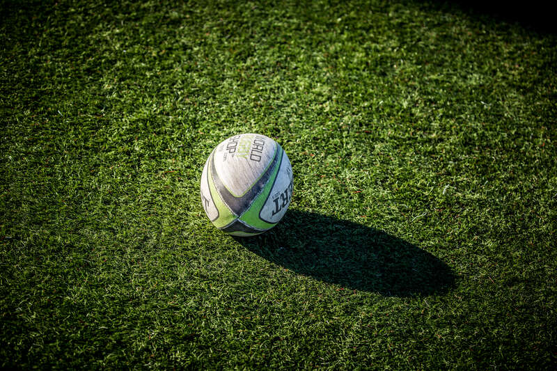 A rugby ball sits on the turf in between games at the Iowa High School Rugby Championship.