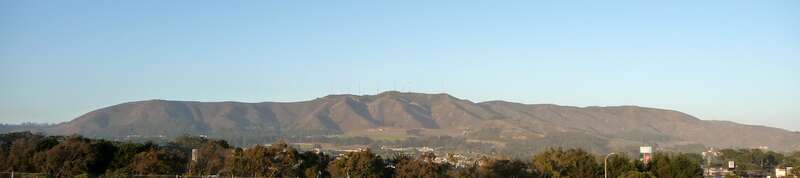 San Bruno Mountain, taken from Seramonte shopping center, Daly City.  Town of Colma is visible in the foreground.