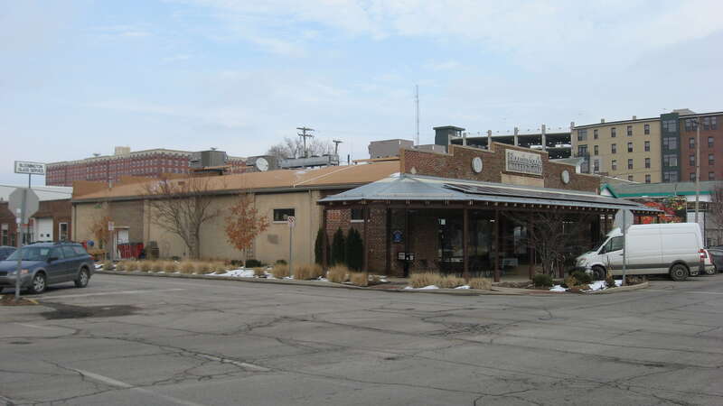 Front and western side of the former Bloomington Garage (now Bloomingfoods), located at 316 W. Sixth Street in Bloomington, Indiana, United States.  Built in 1920, it is a part of the Bloomington West Side Historic District, a historic district that