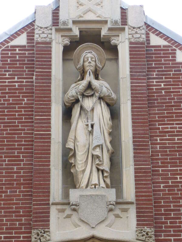 Statue atop Holy Rosary Church, located at the corner of Union Street and Essex Street in Lawrence, Massachusetts.