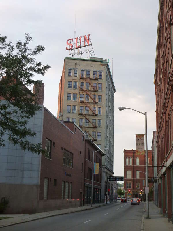 The Lowell Sun building, located at 491 Dutton Street, Lowell, Massachusetts.  Shown are the south and east sides of building, as viewed from Dutton Street.