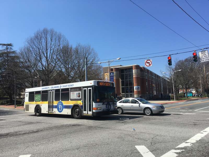 University of Delaware shuttle Gillig Advantage #323 operates along Delaware Avenue at South College Avenue in Newark, Delaware