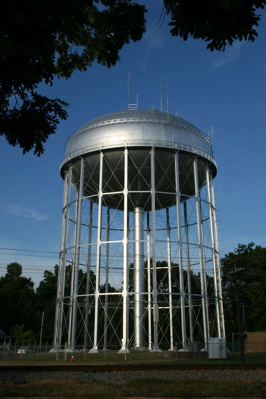 A water tower, viewed across the railroad, in Burlington, North Carolina.