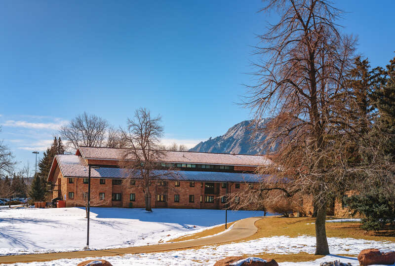 Buckingham Hall undergraduate student housing dorm at the University of Colorado Boulder (CU Boulder) campus in Boulder, Colorado, with the Flatirons in the distance.