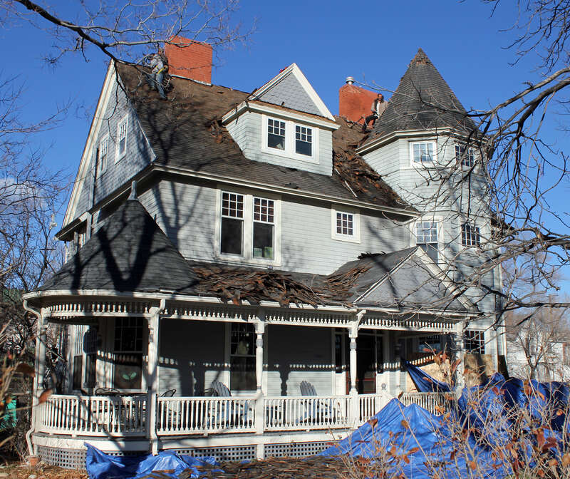 The Burgess House, located at 730 North Nevada Avenue in Colorado Springs, Colorado. The property is listed on the National Register of Historic Places. At the time the photograph was shot, workmen were scraping off the roof.