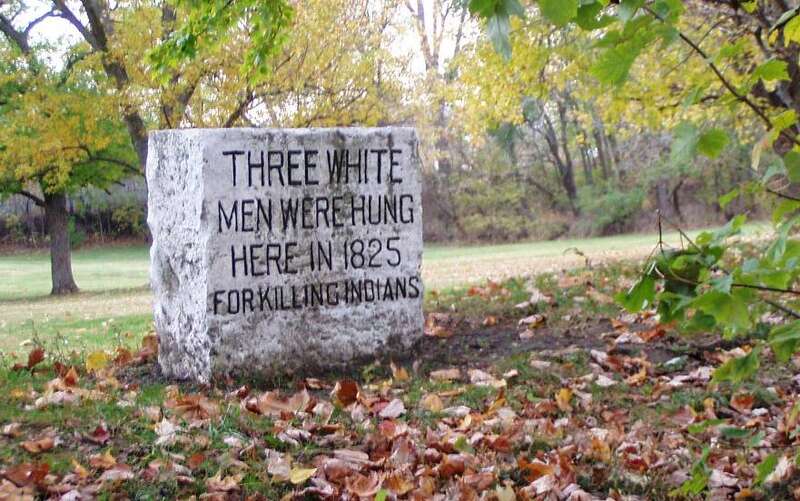 Stone marker commemorating the hangings of the men who committed the Fall Creek Massacre.  The stone is in Fall Creek park in Pendleton, Indiana.  (The stone is on the far side of the creek, near the foot bridge.)