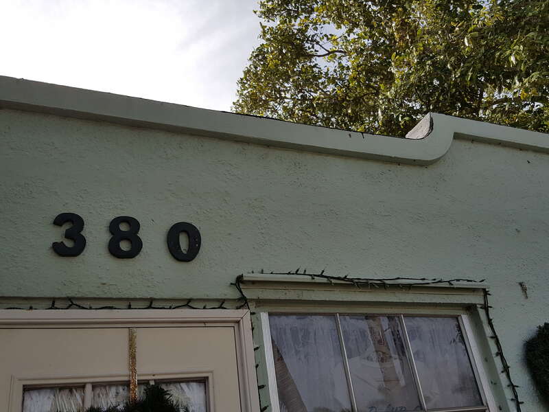 James D. and Alice Butler House detail with house number and roof line