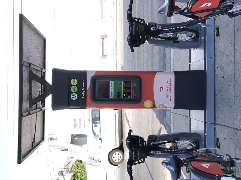 The pay station at the Bagley and Venice Metro Bike Share station, showing the credit card reader and usage instructions.