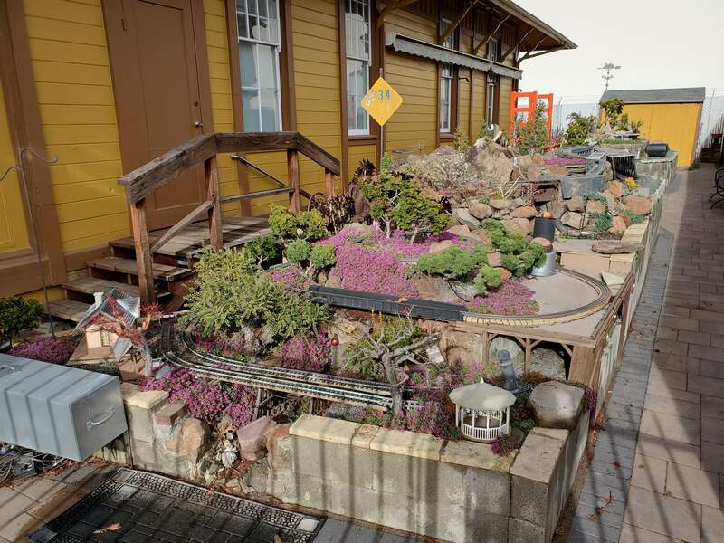 A model train layout behind the former San Leandro station building in February 2021