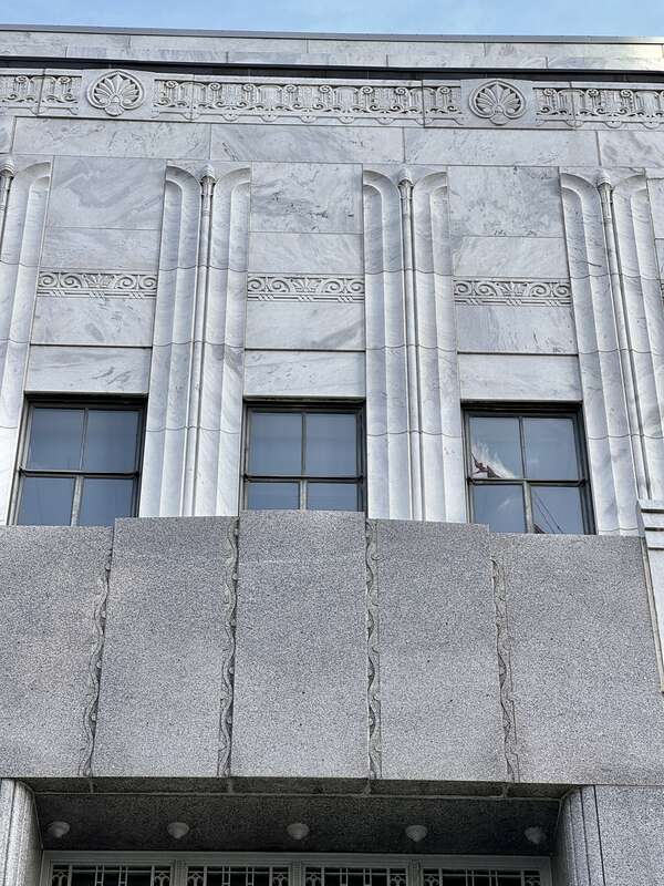 Built in 1932-1934, this Art Deco-style building was designed by Marr and Holman to serve as a United States Post Office for the city of Nashville.  The building is clad in marble with a gray granite base, metal-frame windows, metal spandrels,