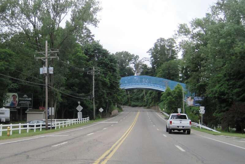 Photo of southbound Pennsylvania Route 832 (Peninsula Drive) in Millcreek Township, Erie County, Pennsylvania. Photo taken looking south between Presque Isle State Park and West 6th Street. A bridge that carries the tracks of Ravine Flyer II in