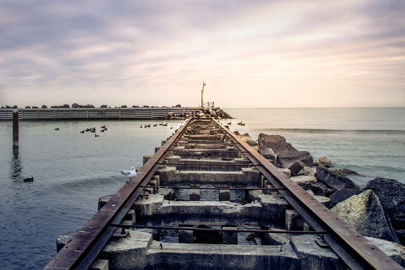 500px provided description: chilly november morning at the old pier and breakwater for the church street power boat ramp in evanston, illinois, near northwestern university.  no powerboats but plenty of ducks and gulls were making use of the