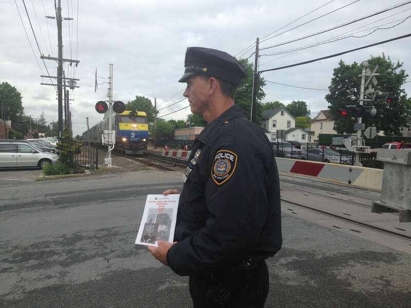 MTA police officers and railroad officials took part in International Level Crossing Awareness Day, or Railroad Crossing Awareness Day, by educating motorists, pedestrians and train customers with safety information. This photo was taken at Long