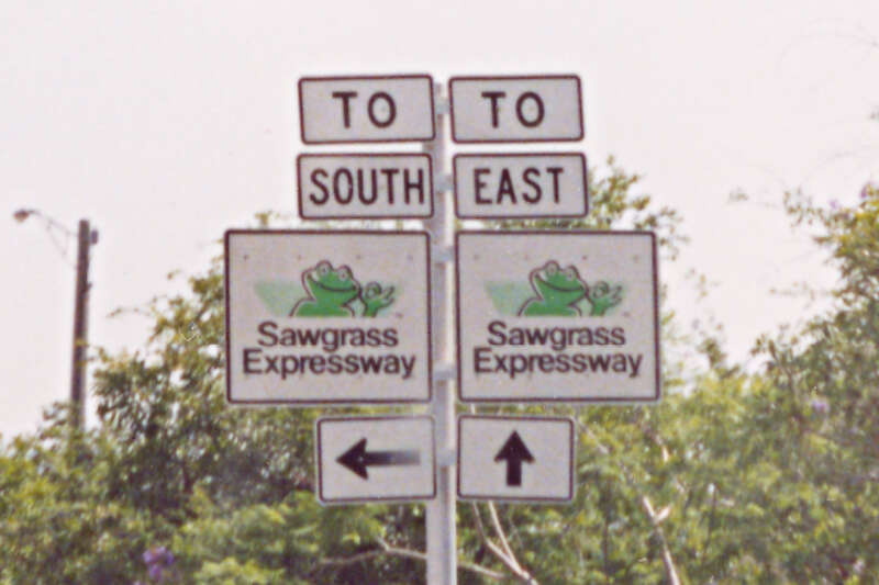 The original road signs pointing to the direction of the Sawgrass Expressway, near the intersection of Atlantic Boulevard and University Drive in the city of Coral Springs, Florida. The signs with the mascot &quot;Cecil B. Sawgrass&quot; were installed in