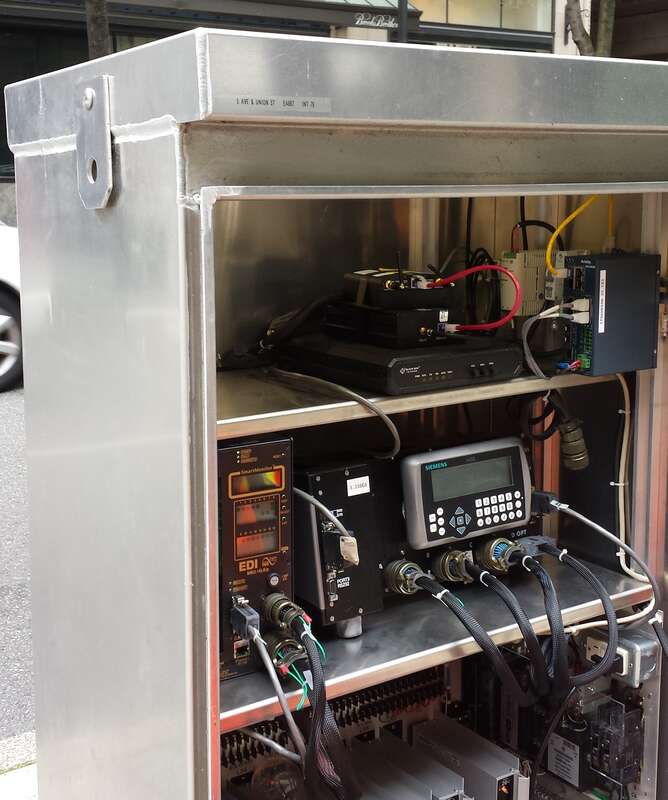 This is the inside of one of the numerous traffic control boxes in Seattle. Long ago, these were now mechanically controlled, now they are all controlled by the Siemens computer on the second shelf.
One the top shelf, the Acyclica surveillance