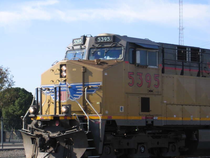 A Union Pacific train runs through Stockton, California headed south past the Western Pacific station house on Union Street.