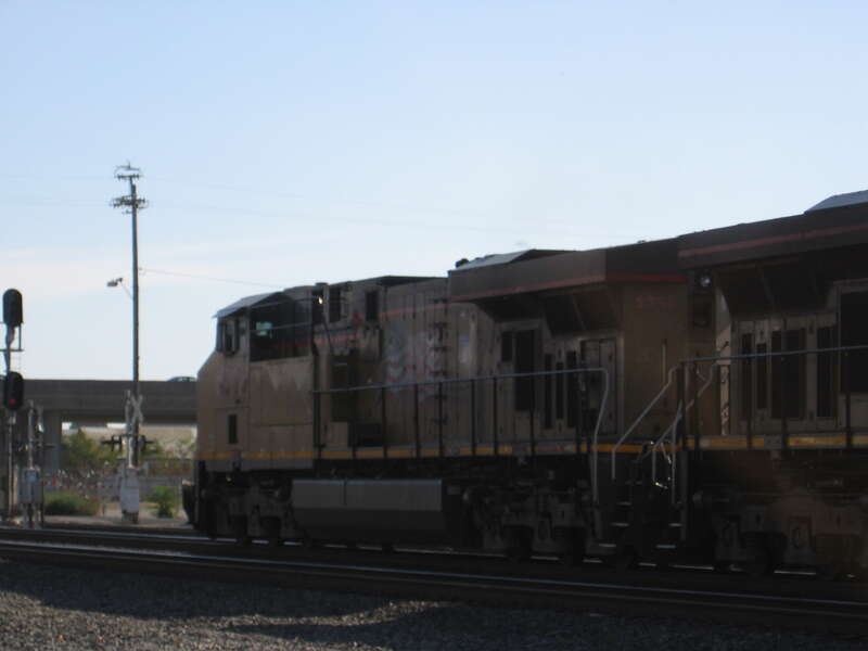A Union Pacific train runs through Stockton, California headed south past the Western Pacific station house on Union Street.