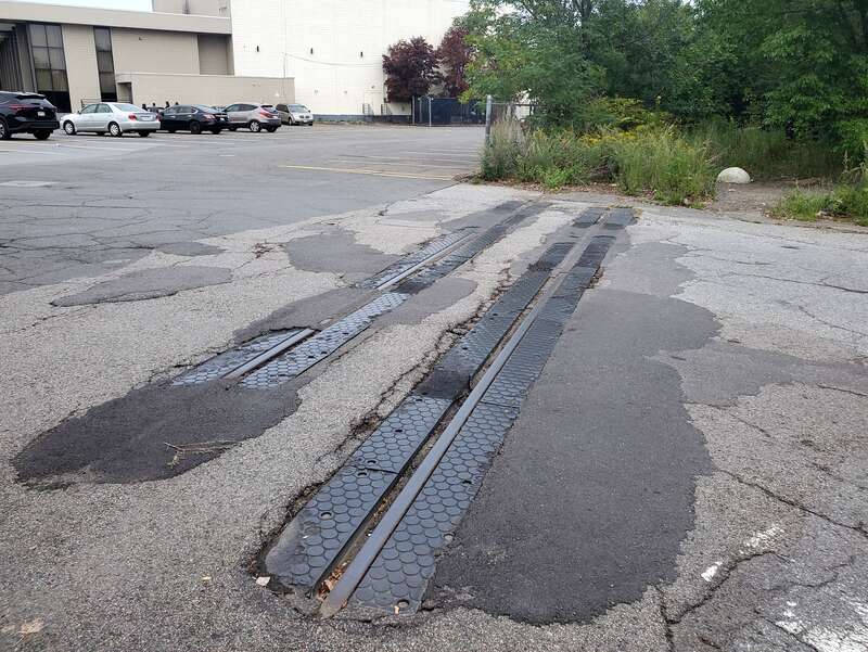 Abandoned Watertown Branch rails crossing New Street in North Cambridge, seen in September 2022