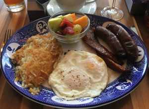 A typical farmer's breakfast in the United States. One typically contains two fried or scrambled eggs, hash browns, chicken or pork sausages, glazed bacons and fruits.