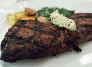 Hickory Grilled NY Strip with roasted fingerling potatoes, local creamed  spinach and black peppercorn butter.  This was a great steak.