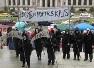 Protest at the Legislative Building in Olympia, Washington (2013.01.14). Reapers. "Big $ in politics kills", "Tar Sands", "Oil &amp; Gas", "Coal", "Deforestation".