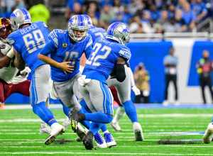 Detroit Lions quarterback, Jared Goff, hands the ball off to running back, D'Andre Swift, in a game against the Washington Commanders at Ford Field, Detroit, MI on September 18, 2022.