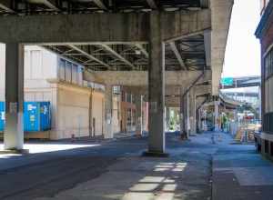 SE 2nd and Morrison Streets under the Morrison Bridge. The John Deere Plow Company building is to the right.