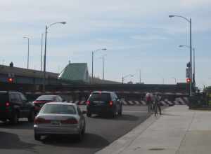Cars and cyclists waiting during a lift of the Clybourn Street Lift Bridge, in Milwaukee, Wisconsin