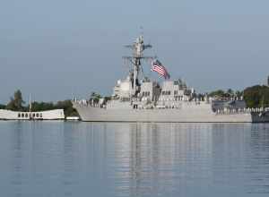 The U.S. Navy destroyer USS Chafee sailing past the USS Arizona Memorial as part of ceremonies commemorating the 69th anniversary of the Pearl Harbor attack.