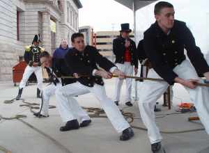 Colorado Springs, Colo. (Mar. 3, 2004) - Seaman William Crandell, Seaman Christopher Cobb and Seaman Anthony Kizer heave hard on a 5,600-pound, 1812-era Naval long gun as Cmdr. Lewin C. Wright, Commanding Officer, USS Constitution, looks on during a