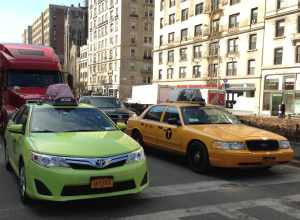 Taxicabs of New York City. Medallion taxi (yellow) on the right. Boro taxi (apple green) on the left.