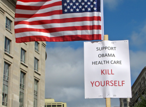 A person holds up a flag with a sign criticizing the Obama healthcare plan at the Taxpayer March on Washington, a Tea Party-affiliated demonstration espousing primarily right-wing values, on September 12, 2009.
More at The Schumin Web:
&lt;a