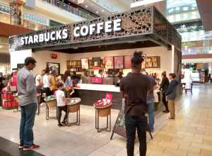 People wait to order as others wait for their coffee at the Galleria Mall in Houston, Texas