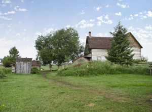Looking southwest from the blacksmith shop at the root cellar and house on the grounds of the Tinsley Living Farm at the Museum of the Rockies in Bozeman, Montana. The chicken coop is to the left, and behind it the storage shed.
The house was