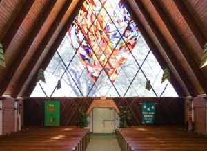 All Faiths Chapel interior, camera POV from stage area facing door. 