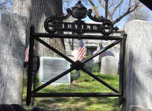 The curved headstone of Washington Irving is seen in the background.