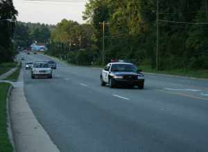 Chapel Hill, North Carolina police cruiser leading the uphill traffic on Franklin St in the evening.