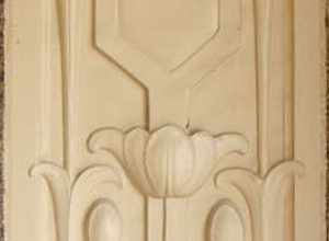 Carved stone inset into brick wall with tulip motif at Denkmann-Hauberg House on the NRHP since December 26, 1972. At 	1300 24th St., Rock Island, Illinois. Prairie School style home designed by Robert C. Spencer. Home to philanthropists John and