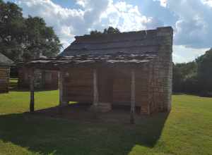 Cabin of squared logs and hand-hewn limestone was built in the early 1850s near the village of Gabriel Mills, Texas.  It stood on property owned in 1850-53 by Samuel Mather (1812-78), miller and blacksmith who first settled the area.  The structure