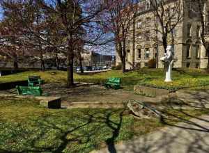As seen on a sunny afternoon in April 2021, this pleasantly shaded green space on the west side of Franklin Street shares its name with the adjacent Catholic cathedral. St. Joseph's Park was dedicated in 1973 on what was once the site of St.