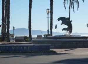 The entrance to Stearns Wharf features a fountain with a statue of dolphins