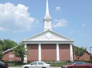 A meetinghouse of The Church of Jesus Christ of Latter-day Saints in New Rochelle, New York. Looking northeast across North Avenue on a sunny hot afternoon.